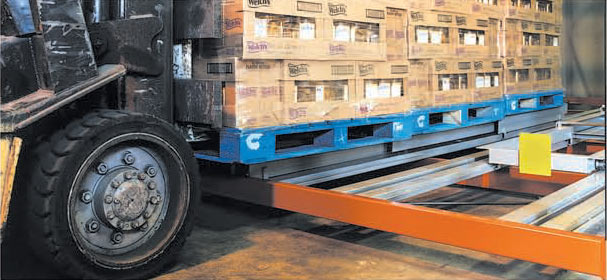 Forklift loading a push-back storage lane
